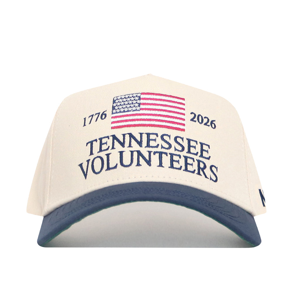 The No Rivals Tennessee Vols 250th Americana Hat is a white snapback with a navy brim, embroidered American flag, "1776," "2026," and "Tennessee Volunteers"—the perfect Gameday fit.