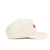The No Rivals Nebraska Sideline Hat is a cream-colored structured-fit cap with a curved brim and partially visible red embroidery on the front. Made from high-quality cotton, this stylish snapback hat offers lasting comfort and durability.