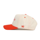 The Clemson Vintage Hat by No Rivals features a cream base, red brim, red stitching, and red NR initials on the side—perfect for gameday style with its easy snap back closure.