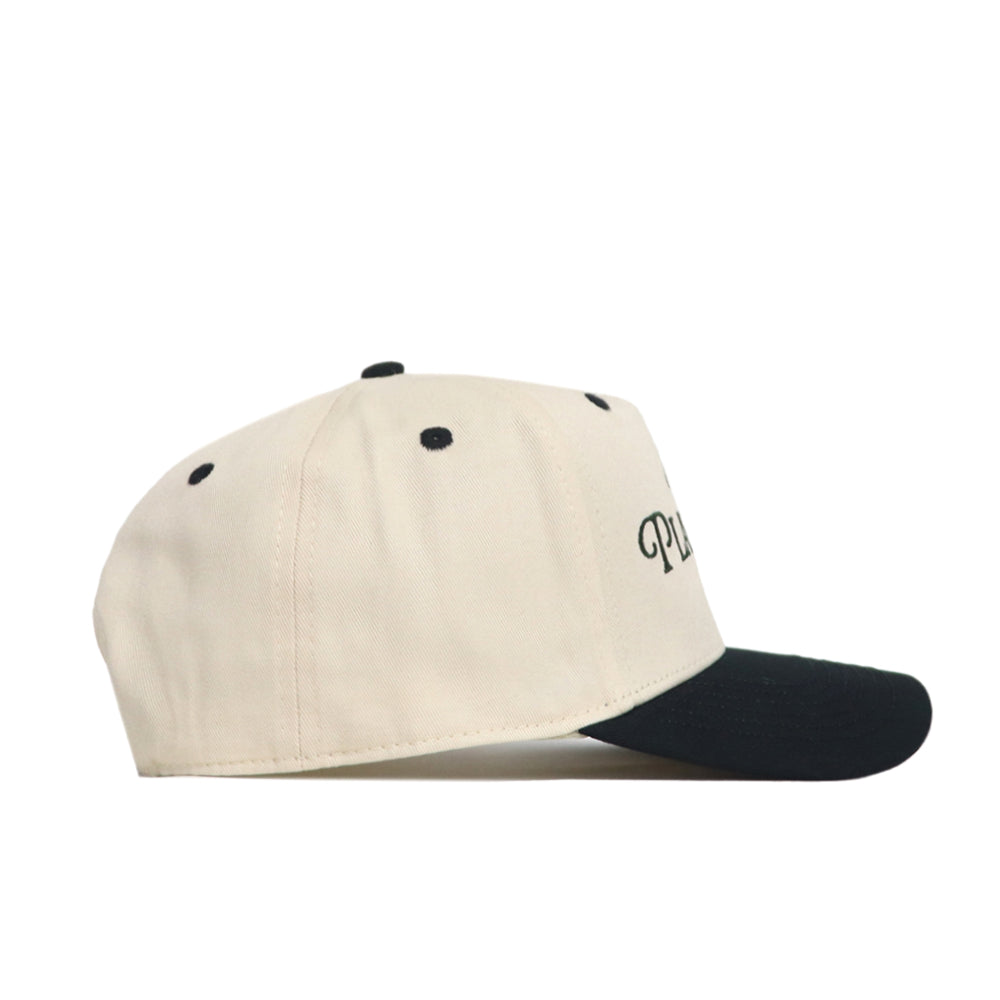 The No Rivals Play Golf Hat - Classic Black features a beige snapback design with a black brim, black eyelets, and a partial black embroidered logo—shown in a side view on white. The perfect pick for any gameday look.