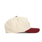 The No Rivals Iowa State Halftime Hat is a cream snapback with a burgundy brim, crafted from premium cotton and shown from the side on a white background.