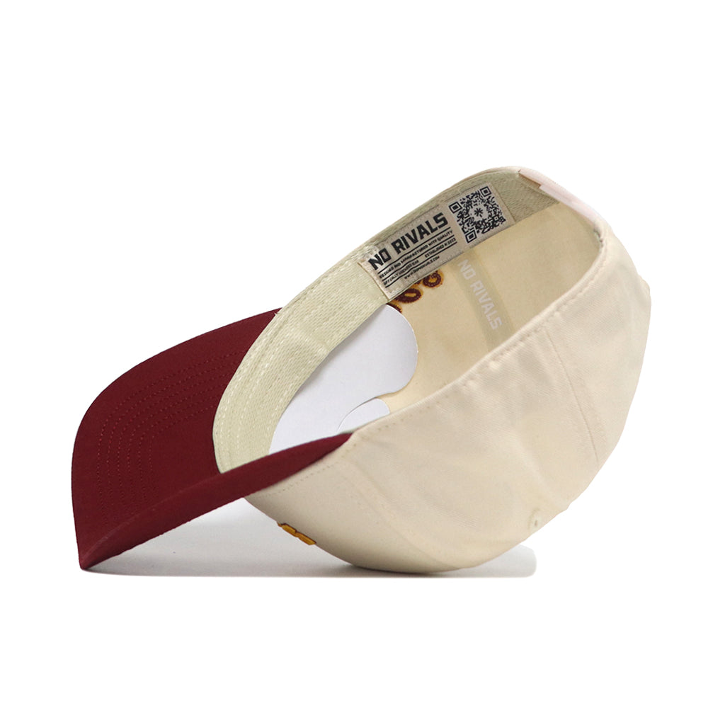The Iowa State Halftime Hat by No Rivals is shown upside down, displaying its inner "NO RIVALS" tag and a QR code on the band. Made from premium cotton, it features a cream body with a maroon brim.