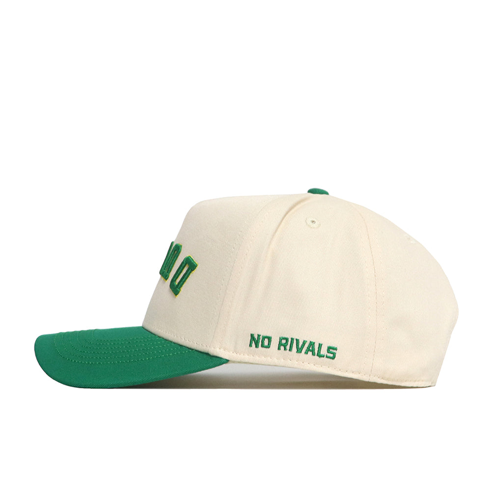 The Upside Down Ducks Hat - Oregon - Classic by No Rivals is a cream snapback with a green brim, made from premium cotton. "NO RIVALS" is embroidered in green on the side for structured fit and standout style.