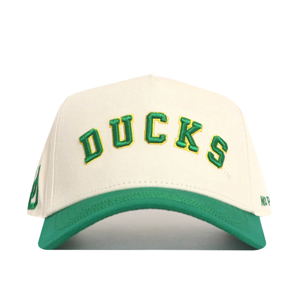 The No Rivals Right Side Up Ducks Hat - Oregon - Classic features a white cap with DUCKS embroidered in green and yellow, a green brim, and an officially licensed snapback for the perfect fit.