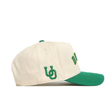 The No Rivals Right Side Up Ducks Hat - Oregon - Classic is a cream snapback baseball cap with a green brim, green UD side logo, and yellow-green embroidered text on the front.