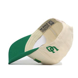 The Right Side Up Ducks Hat - Oregon - Classic by No Rivals is a cream and green snapback cap, shown on its side with the green bill underneath and interior tags visible. The front has an officially licensed, green embroidered S and T monogram.