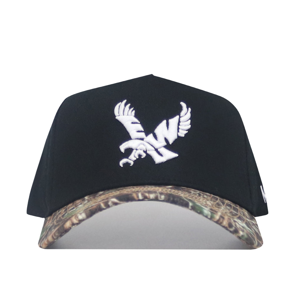 The No Rivals EWU Camo Hat - Trailblazer Edition is a black snapback crafted from premium cotton, with a structured fit, white eagle embroidery on the front, and a camo-patterned brim.
