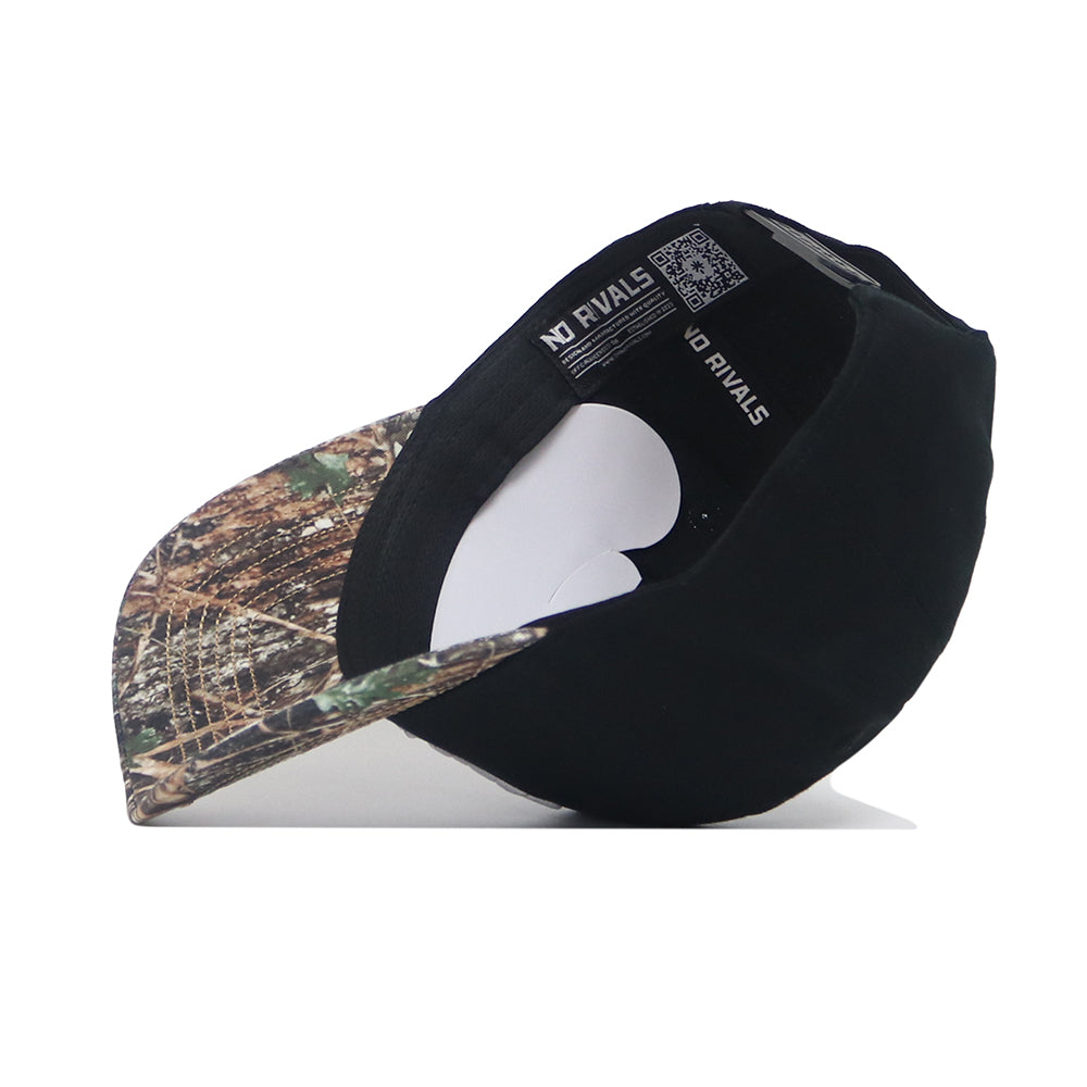 The EWU Camo Hat - Trailblazer Edition by No Rivals features a black snapback with a camo brim, shown upside down to highlight the structured fit, white paper inserts, and visible No Rivals brand tags inside.