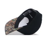 The EWU Camo Hat - Trailblazer Edition by No Rivals features a black snapback with a camo brim, shown upside down to highlight the structured fit, white paper inserts, and visible No Rivals brand tags inside.