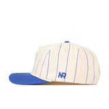 The No Rivals Kansas Pinstripe Hat is a cream snapback baseball cap with thin blue stripes, a blue bill, and "NR" embroidered in blue on the side.