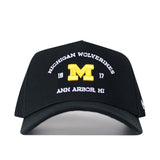The Michigan Wolverines Outlaw Hat - Black by No Rivals is the perfect snapback for your gameday fit, showcasing bold white and yellow embroidery on the front with “Michigan Wolverines,” a yellow M, “1817,” and “Ann Arbor, MI” for an eye-catching logo look.