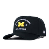 The Michigan Wolverines Outlaw Hat in black by No Rivals features a prominent yellow “M” and white embroidered text that reads “Michigan Wolverines 1817 Ann Arbor, MI” on the front. A white No Rivals logo is embroidered on the side. This cap offers a curved brim, structured front panel, and adjustable snapback closure for an ideal gameday fit.