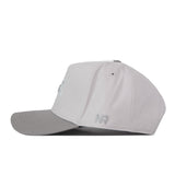 A side view of the No Rivals NDSU Graphite Hat shows its light gray snapback design with a darker gray curved brim, stitched eyelets, and an embroidered NR logo near the edge—perfect for elevating your gameday fit.