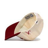 The Upside Down ALABAMA Hat by No Rivals is shown flipped to reveal its inside label with "NO RIVALS" and a QR code. This classic color cap features a red brim, structured fit, and an embroidered red "A" on the cream panel.