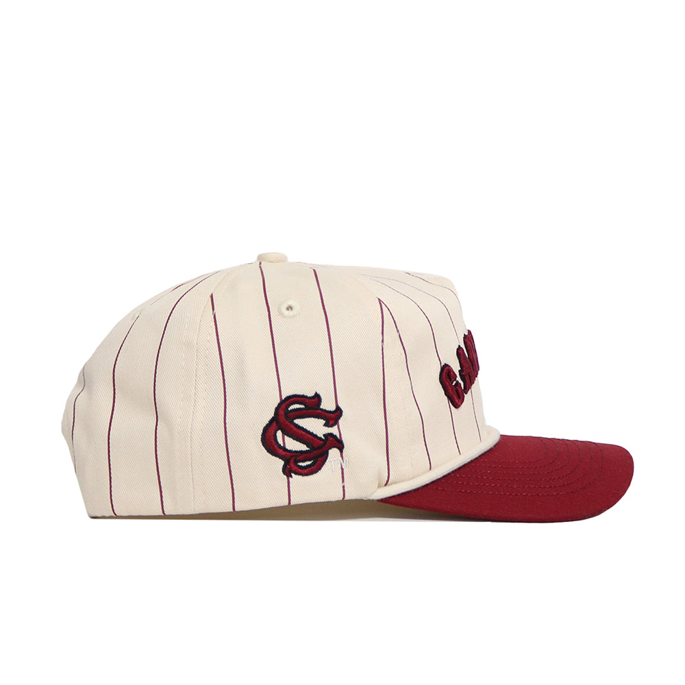 The No Rivals South Carolina Walk Off Hat is a cream cotton cap with thin maroon pinstripes, an unstructured fit, a solid maroon brim, and a maroon SC logo embroidered on the side.