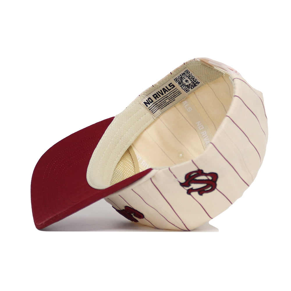 The South Carolina Walk Off Hat by No Rivals is a cream cotton cap with red pinstripes, red brim, and embroidered logos. It has an unstructured snapback fit and an inside label reading "NO RIVALS," with interior details visible from a side view.