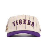 The No Rivals LSU Walk Off Hat is a cream snapback with thin vertical purple stripes, purple TIGERS text on the front, a purple brim, cotton fabric, unstructured fit, and the LSU tiger logo on the left side.