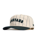 The Michigan State Walk Off Hat by No Rivals features cream cotton fabric with navy pinstripes, a dark green brim, "SPARTANS" embroidered in green on the front, and a small black logo on the side.