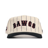 The No Rivals Georgia Walk Off Hat is a cream snapback with black pinstripes, "DAWGS" in bold black and red letters on the front, a black brim, side logo patch, and is crafted from high quality cotton.