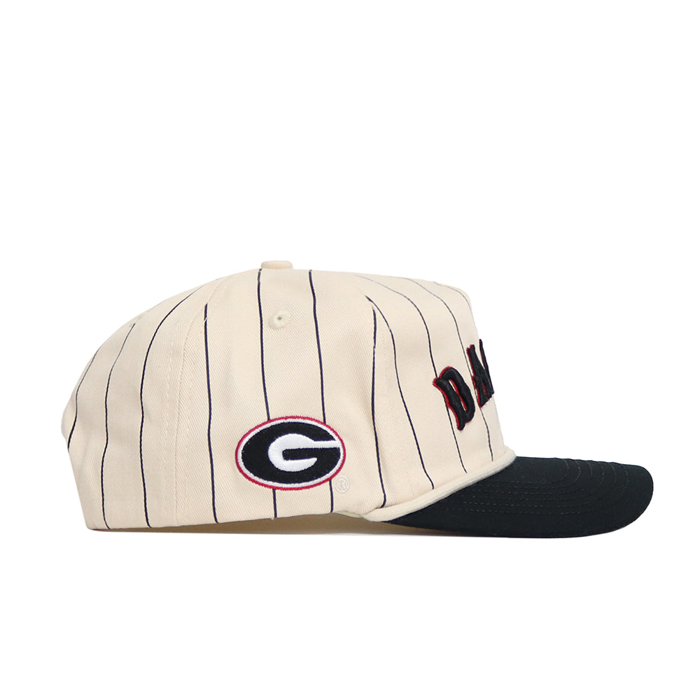 The No Rivals Georgia Walk Off Hat features a beige snapback design with thin black stripes, a black brim, and an embroidered G logo outlined in red and black on the side. Made from high quality cotton for an unstructured fit.