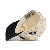 The Georgia Walk Off Hat by No Rivals is a cream snapback baseball cap with thin black stripes, a black visor, and a side G logo. Made from high-quality cotton with an unstructured fit, it features a NO RIVALS band and inner QR code.