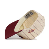 The Virginia Tech Walk Off Hat by No Rivals is a cream snapback with thin maroon stripes, a maroon brim, and a stylized maroon S logo on the side. Shown upside down, it reveals its unstructured fit and inside lining labeled NO RIVALS.