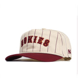 The No Rivals Virginia Tech Walk Off Hat is a cream snap back with thin maroon pinstripes, a maroon brim, “HOKIES” embroidered in maroon and gold on the front, cotton fabric, an unstructured fit, and a stitched New Era logo.
