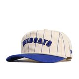 The No Rivals Kentucky Walk Off Hat features a cream unstructured fit with thin blue stripes, a blue brim, and "WILDCATS" boldly embroidered in blue on the front.