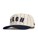 The Georgia Tech Walk Off Hat by No Rivals features high-quality cotton with thin navy pinstripes, bold TECH front lettering, a flat navy brim, side N logo, and adjustable snapback for a perfect fit.