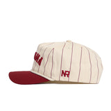 The Alabama Walk Off Hat by No Rivals features a cream cotton body with thin maroon vertical stripes, a maroon brim, and maroon "NR" embroidery on the side. This adjustable baseball cap is displayed in side profile.