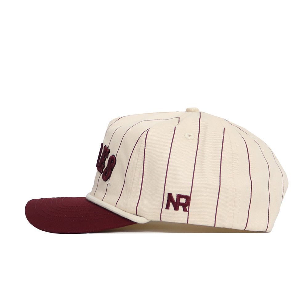 The No Rivals Texas A&M Walk Off Hat is a cream snapback crafted from premium cotton, with thin vertical burgundy stripes, a burgundy brim, and raised "NR" embroidery on the side. The product is displayed from a side view.