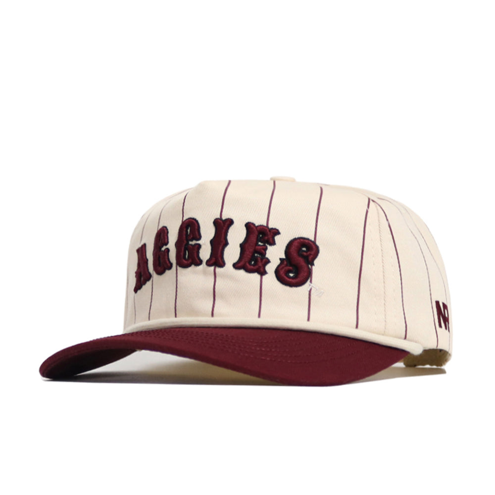 The No Rivals Texas A&M Walk Off Hat features cream cotton with thin maroon pinstripes, "AGGIES" embroidered in bold maroon, a maroon brim, and an unstructured snapback fit for comfort.