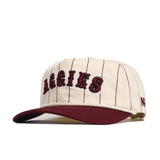 The No Rivals Texas A&M Walk Off Hat features cream cotton with thin maroon pinstripes, "AGGIES" embroidered in bold maroon, a maroon brim, and an unstructured snapback fit for comfort.