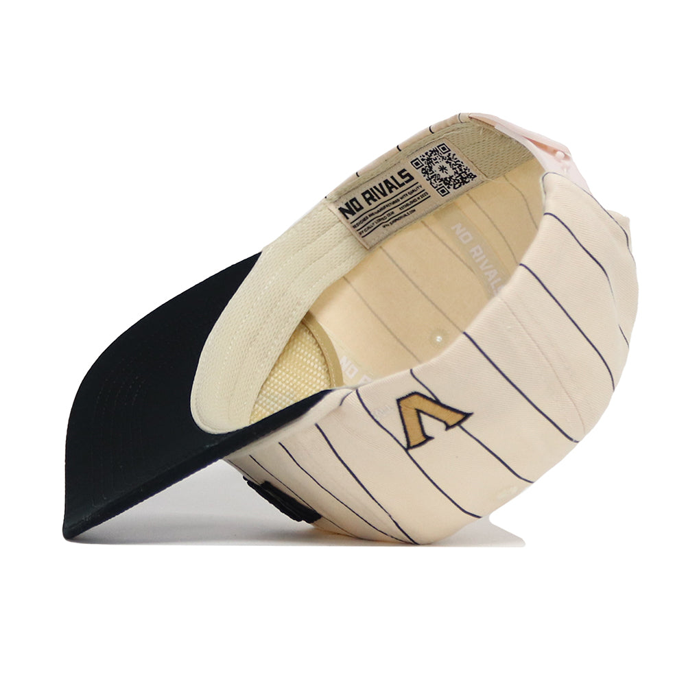 The Vanderbilt Walk Off Hat by No Rivals is a cream pinstriped cotton cap with a black brim, shown inside out to reveal its tags, stitching, and NO RIVALS printed on the adjustable inner band.