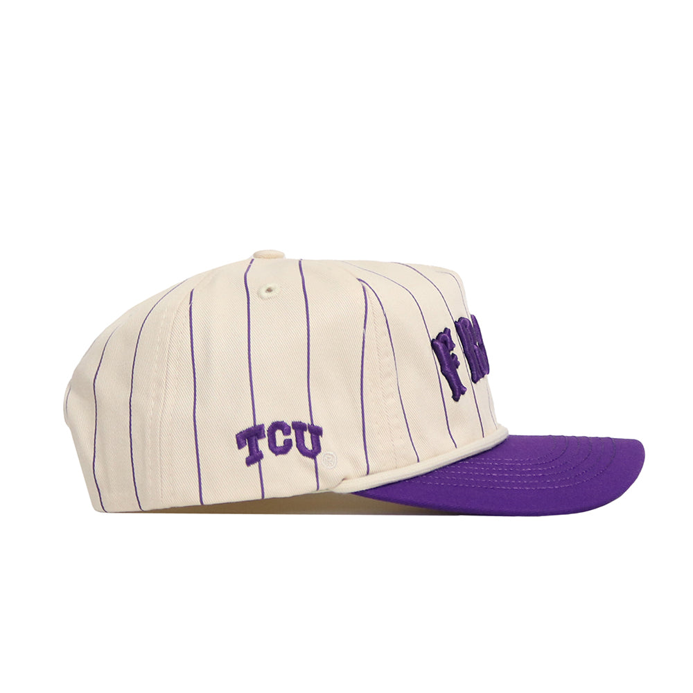 The TCU Walk Off Hat by No Rivals features a cream snapback design with thin purple vertical stripes, a purple brim, and "TCU" embroidered on the side. Made from soft cotton for an unstructured fit.