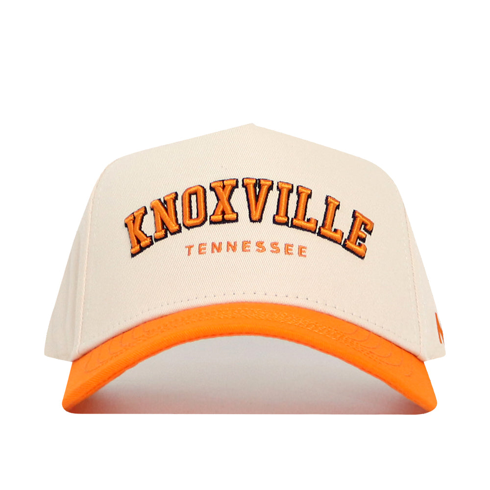 The No Rivals Knoxville Hometown Hat is a beige snapback baseball cap with an orange brim, featuring "KNOXVILLE" in large orange letters and "TENNESSEE" below on the front, crafted from high-quality cotton with a structured fit.