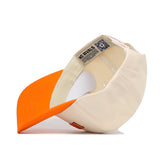 The Knoxville Hometown Hat by No Rivals is shown from underneath, highlighting its beige and orange snapback, inner lining, structured stitching, and a label with "NO RIVALS" plus a QR code.