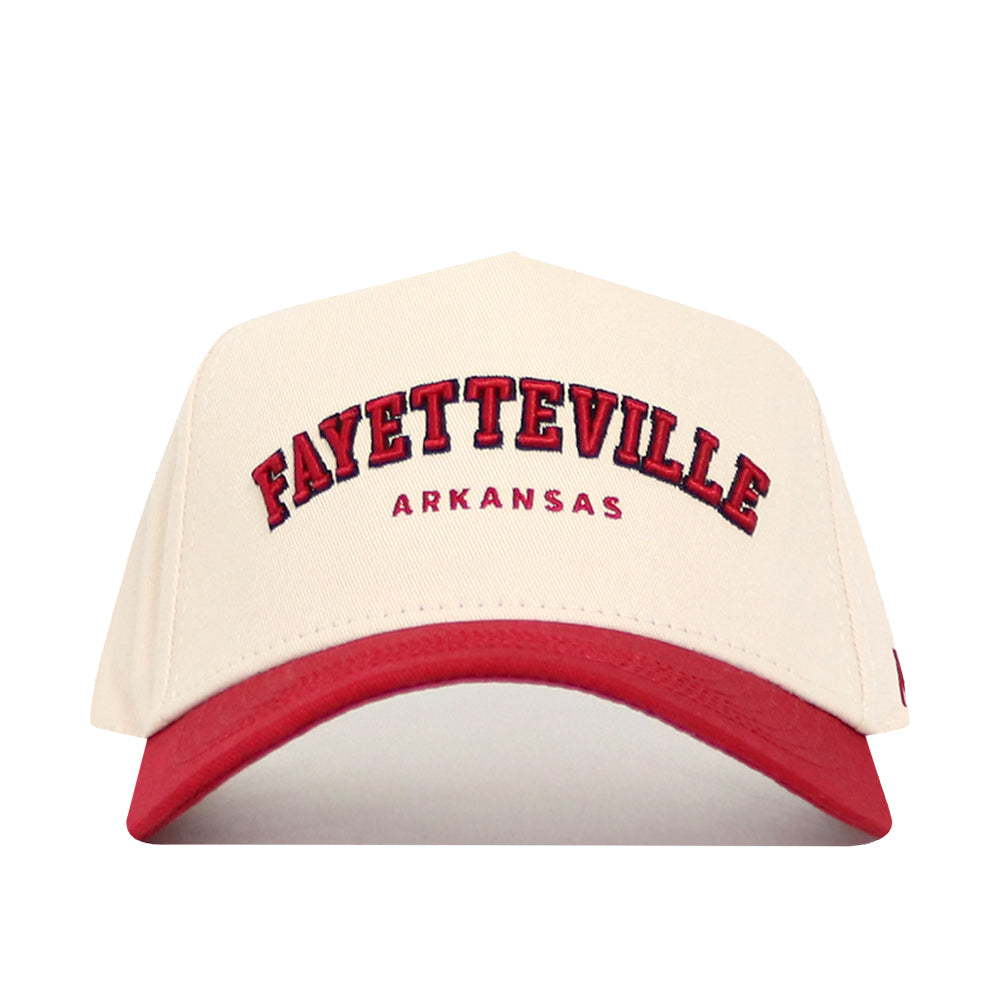The No Rivals Fayetteville Hometown Hat is a cream, structured-fit cap with a red brim. Made of quality cotton, it features bold red "Fayetteville" text outlined in black, "Arkansas" beneath, and an adjustable snapback for a perfect fit.