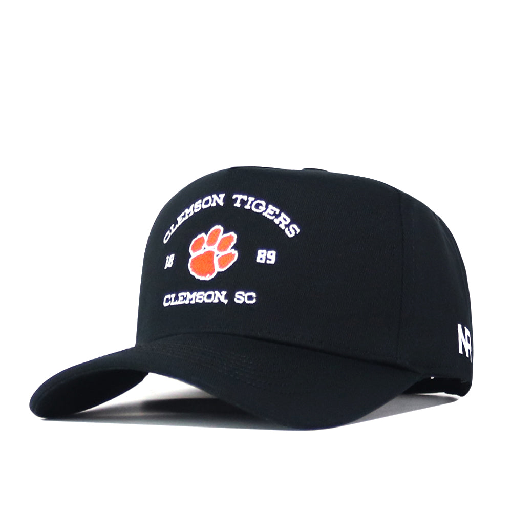 The Clemson Outlaw Hat - Black by No Rivals features “Clemson Tigers 1889 Clemson, SC” text and an orange tiger paw embroidered on the front—perfect for your next gameday fit.
