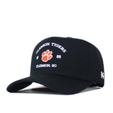 The Clemson Outlaw Hat - Black by No Rivals features “Clemson Tigers 1889 Clemson, SC” text and an orange tiger paw embroidered on the front—perfect for your next gameday fit.