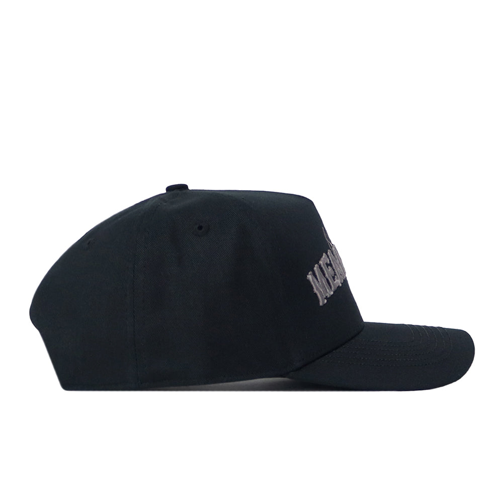 The UNT Night Mode Hat by No Rivals is a black snapback, shown in profile facing right, featuring partial white embroidered logos on the front.