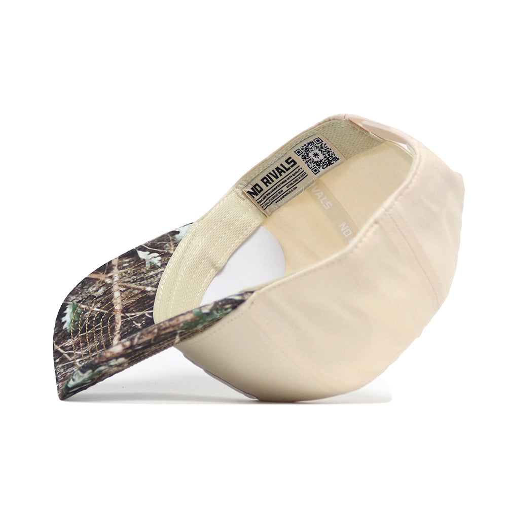 The Oregon Camo Connector Hat by No Rivals features a beige crown and camouflage-patterned brim. Shown upside down to highlight its interior and bold “NO RIVALS” label, it’s the perfect way to elevate your gameday fit.