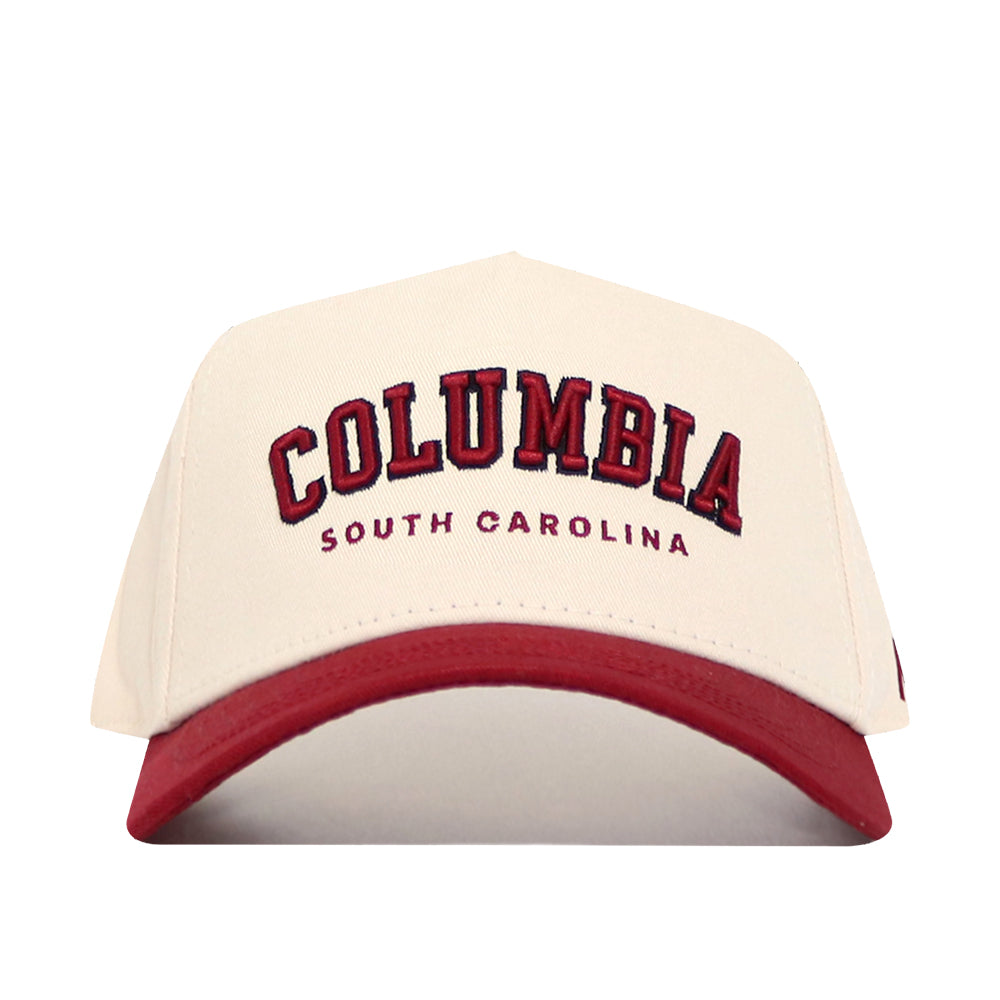 The No Rivals Columbia Hometown Hat is a cream snapback with a bold red brim, featuring large red "COLUMBIA" lettering and "SOUTH CAROLINA" below. Made from high-quality cotton for structured fit and lasting comfort.