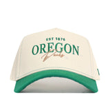 The No Rivals Oregon Vintage Hat is an officially licensed white and green snapback featuring an embroidered EST 1876 OREGON Ducks logo in green and gold on the front.