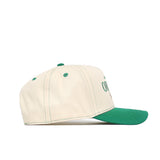 The No Rivals Oregon Vintage Hat is a cream-colored baseball cap with a green brim, top button, stitching, and eyelets. Shown in side view, it features an embroidered logo for an officially licensed look.