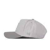 The No Rivals Boise State Graphite Hat is a light gray baseball cap with a slightly darker gray brim, shown from the side. It features small ventilation holes, a subtle embroidered logo near the back, and a classic snap back closure—perfect for finishing off your gameday look.