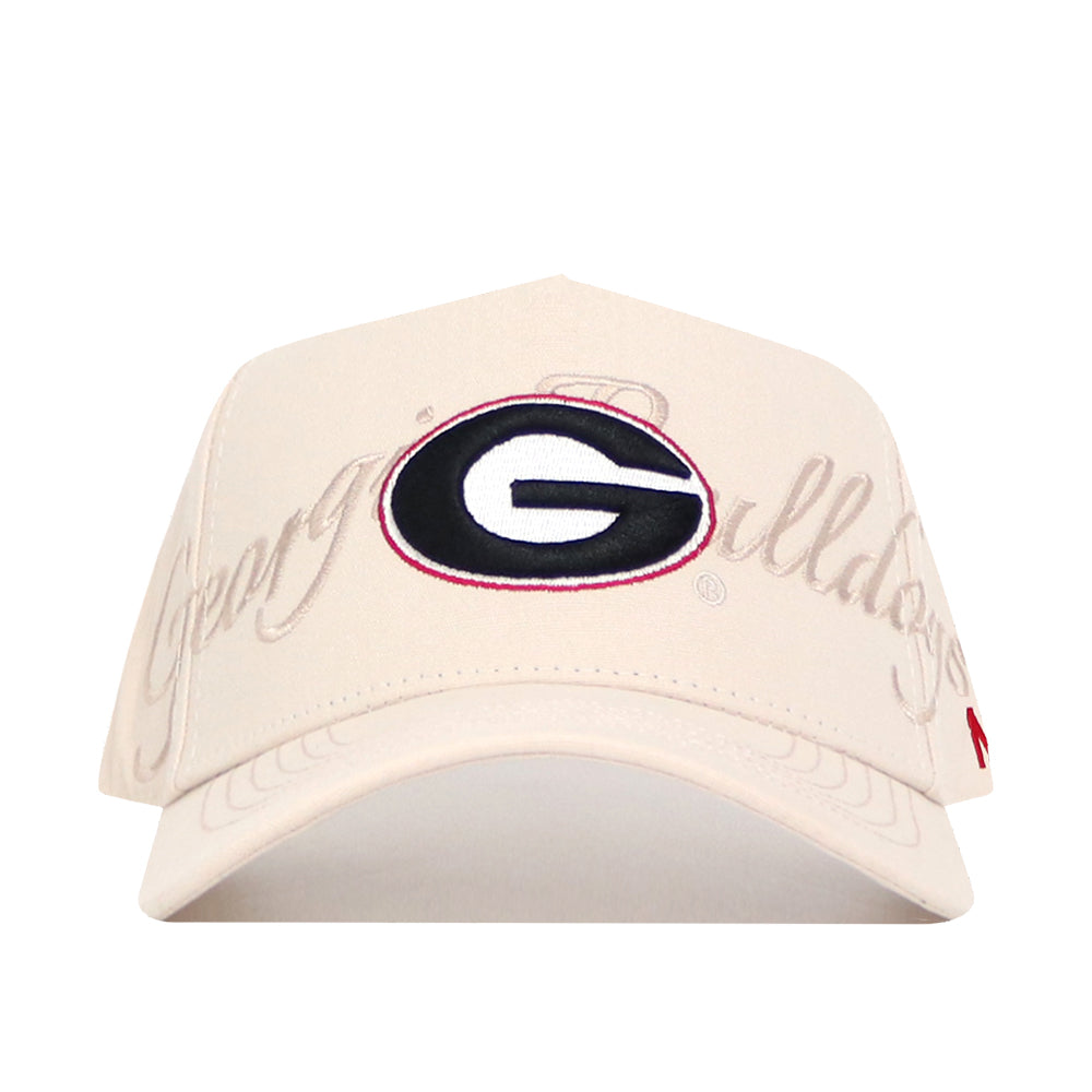 The No Rivals Georgia Stacked Hat is a beige cotton baseball cap featuring a center embroidered black and red G logo with "Georgia Bulldogs" stitched in script across the front.