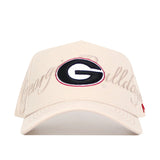 The No Rivals Georgia Stacked Hat is a beige cotton baseball cap featuring a center embroidered black and red G logo with "Georgia Bulldogs" stitched in script across the front.