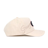 The Georgia Stacked Hat by No Rivals features a beige structured fit, curved brim, ventilation eyelets, high-quality cotton, “Georgia” embroidered in cursive on the side, and a stylized G logo on the front.