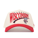 The No Rivals Wisconsin Badgers Stride Hat features a cream and red design with bold Wisconsin Badgers text and a striking Bucky Badger mascot logo on the front. Crafted from high-quality cotton for lasting comfort, this structured snapback hat offers both style and durability, making it the perfect choice for devoted fans.